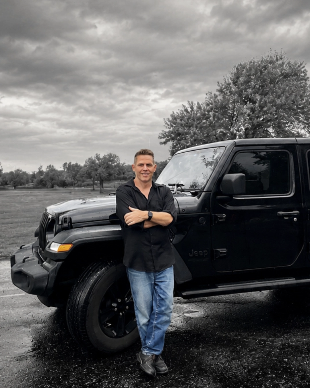 Ray Kennedy standing beside his Jeep, outdoors